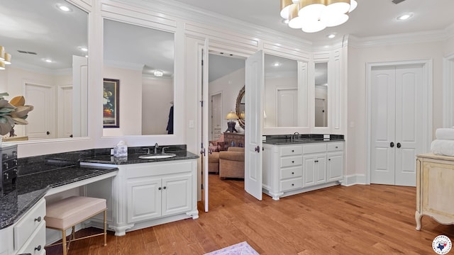 6804 Springwood Cir, Texarkana, TX 75503 - ensuite bathroom featuring a chandelier, two vanities, wood finished floors, crown molding, and recessed lighting