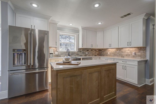 kitchen featuring white cabinets, high quality fridge, and dark hardwood / wood-style flooring