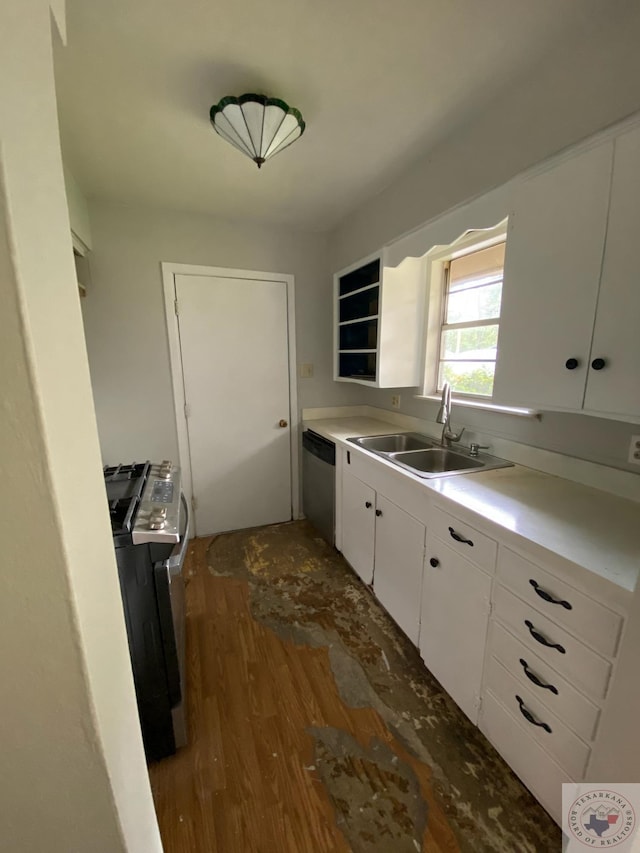 kitchen featuring dark wood-type flooring, washer / dryer, sink, appliances with stainless steel finishes, and white cabinets