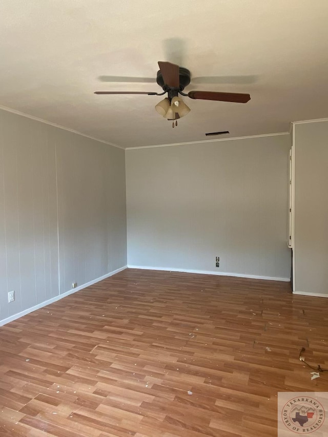 empty room featuring ceiling fan, ornamental molding, and light wood-type flooring