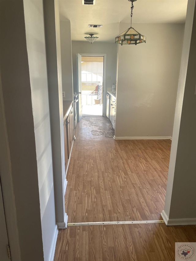 hallway with wood-type flooring