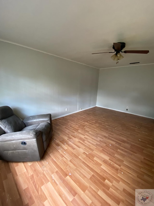 unfurnished room with crown molding, light wood-type flooring, and ceiling fan