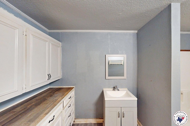 2006 Walnut St, Texarkana, TX 75501 - bathroom with vanity, a textured ceiling, wood finished floors, and ornamental molding