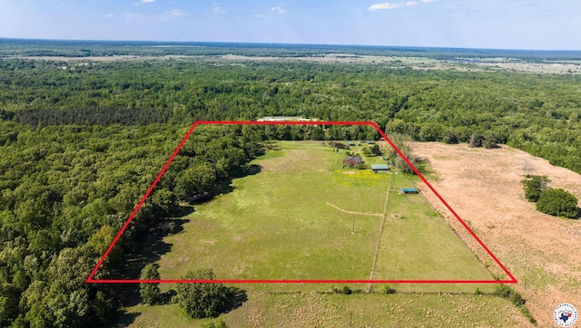 birds eye view of property with a wooded view
