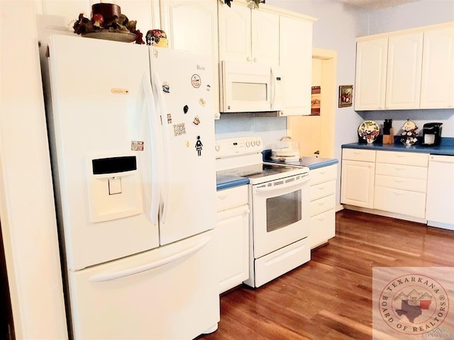 kitchen featuring white appliances and dark hardwood / wood-style flooring