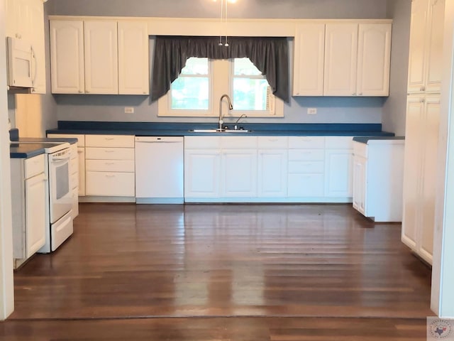 kitchen featuring white cabinetry, sink, white appliances, and dark wood-type flooring