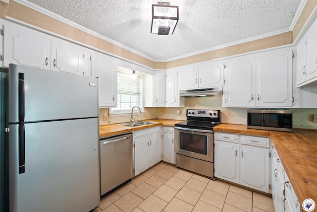 218 Redwood Dr, Texarkana, TX 75501 - kitchen with appliances with stainless steel finishes, wooden counters, under cabinet range hood, and a sink