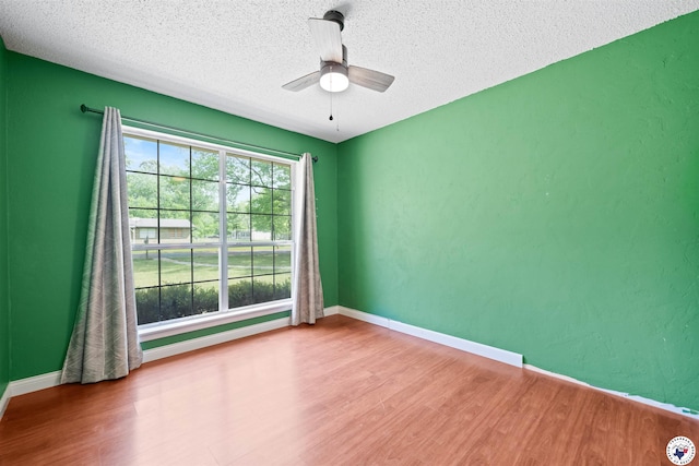218 Redwood Dr, Texarkana, TX 75501 - unfurnished room with wood finished floors, a textured ceiling, baseboards, and ceiling fan