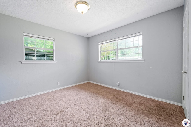 218 Redwood Dr, Texarkana, TX 75501 - unfurnished room with carpet floors, a textured ceiling, and baseboards