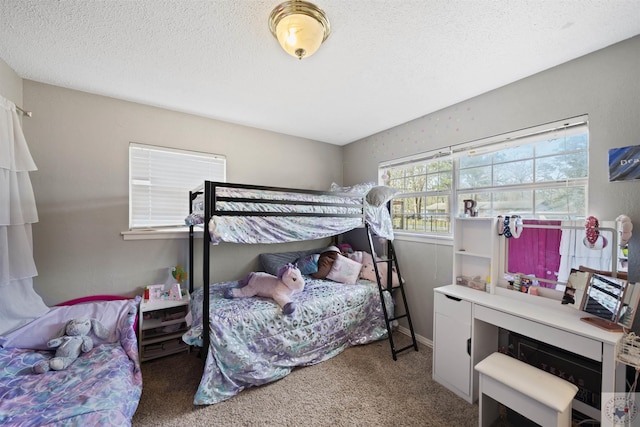 carpeted bedroom featuring a textured ceiling and baseboards