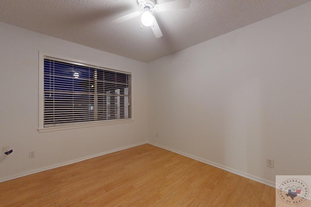 empty room featuring ceiling fan, light hardwood / wood-style flooring, and a textured ceiling