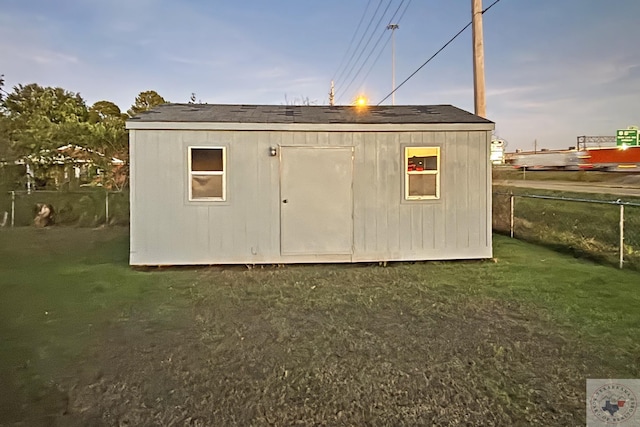 outdoor structure at dusk with a lawn