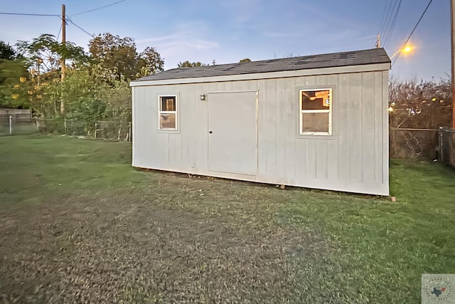 outdoor structure at dusk with a yard