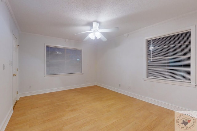 spare room with ceiling fan, a textured ceiling, light hardwood / wood-style flooring, and crown molding