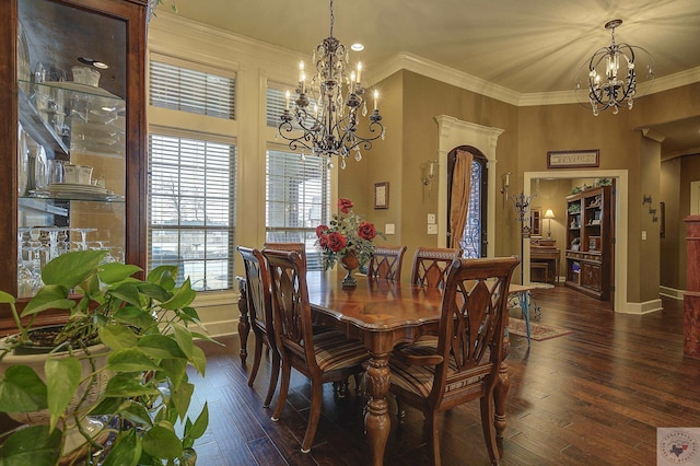 dining area with dark wood-style floors, baseboards, a chandelier, and ornamental molding