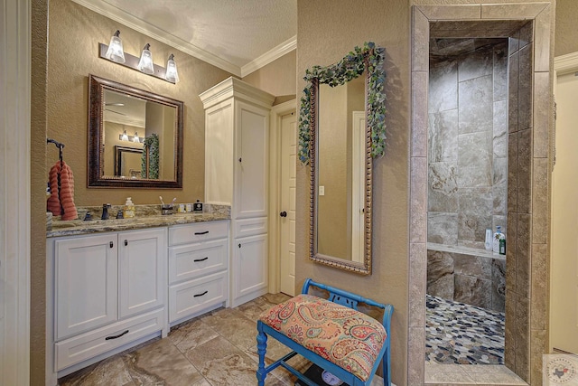 bathroom with crown molding, a textured wall, vanity, a textured ceiling, and a walk in shower