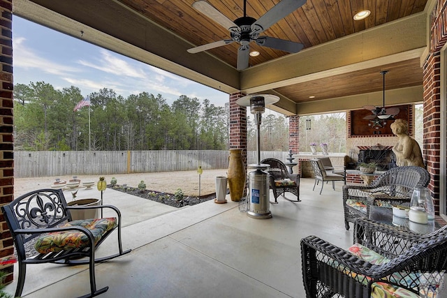 view of patio featuring a fenced backyard, ceiling fan, and an outdoor living space