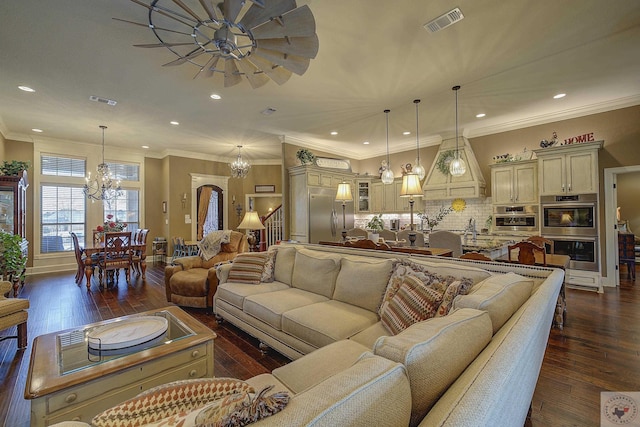 living area featuring dark wood-style floors, crown molding, visible vents, and recessed lighting