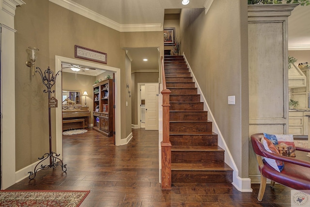 foyer entrance with stairs, dark wood-type flooring, baseboards, and crown molding