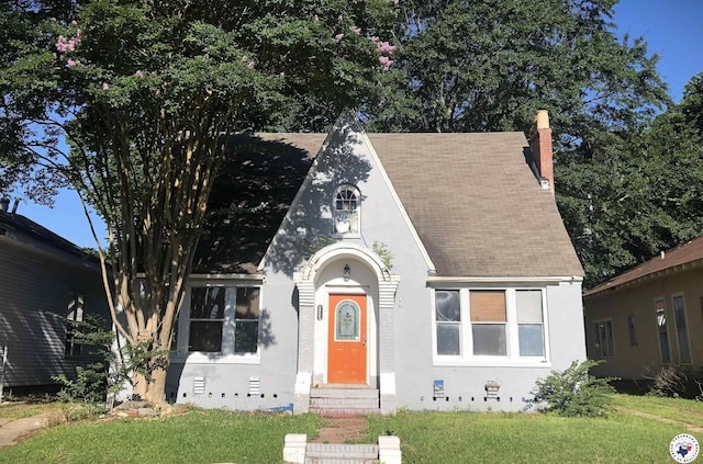 2203 Locust St, Texarkana, AR 71854 - view of front of house with entry steps, a front yard, a chimney, and a shingled roof