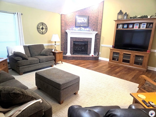 6133 Timberwood Ln, Texarkana, AR 71854 - living room featuring vaulted ceiling, wood finished floors, and a brick fireplace