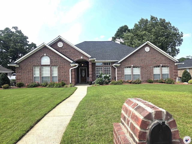 6133 Timberwood Ln, Texarkana, AR 71854 - view of front facade featuring brick siding, a front yard, and a shingled roof