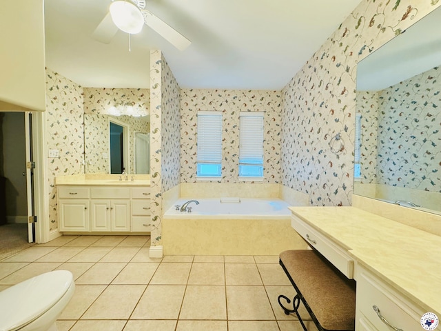 bathroom featuring tile patterned floors, wallpapered walls, a ceiling fan, and a garden tub
