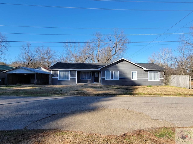 ranch-style home with a front yard and a carport