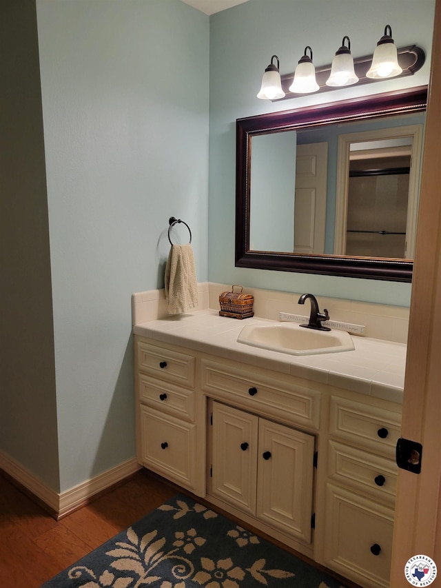 30 Hickory Oak Ln, Texarkana, TX 75501 - bathroom featuring baseboards, wood finished floors, and vanity