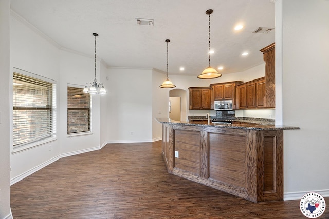 3604 Melody Ln, Texarkana, TX 75503 - kitchen featuring stainless steel microwave, brown cabinets, dark wood-style floors, baseboards, and ornamental molding