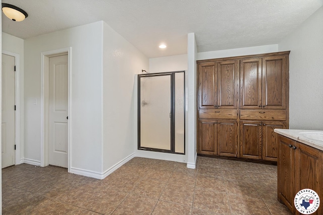 3604 Melody Ln, Texarkana, TX 75503 - full bathroom with a stall shower, vanity, tile patterned floors, and baseboards