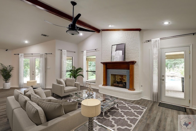 living room with french doors, a brick fireplace, vaulted ceiling with beams, and dark wood-type flooring