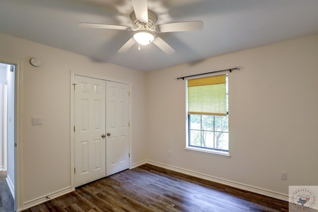 unfurnished bedroom featuring a closet, ceiling fan, and dark wood-type flooring