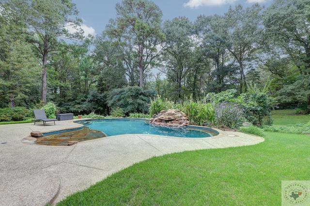 view of swimming pool featuring a yard and a patio