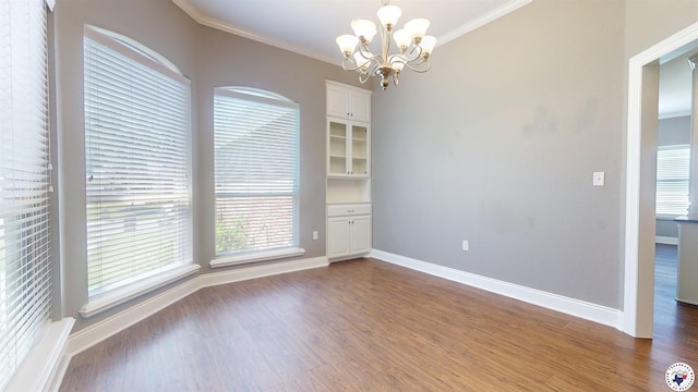 6908 Woodmere Ct, Texarkana, TX 75503 - empty room with crown molding, a chandelier, and wood finished floors