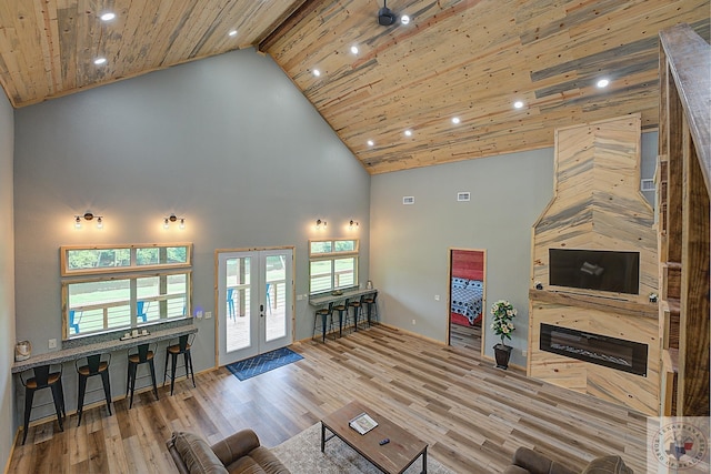 living room with high vaulted ceiling, wood-type flooring, beamed ceiling, and french doors