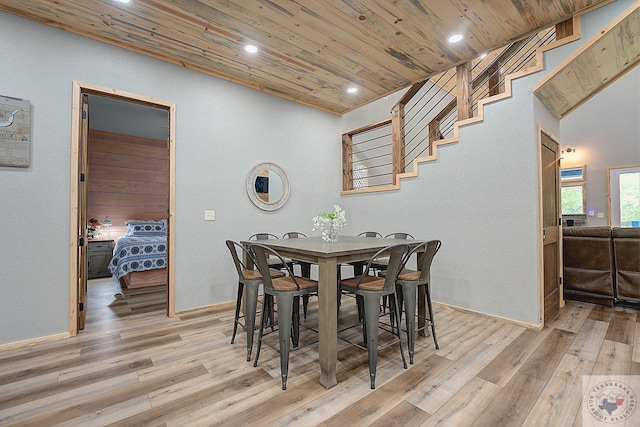 dining room with light hardwood / wood-style floors and wood ceiling