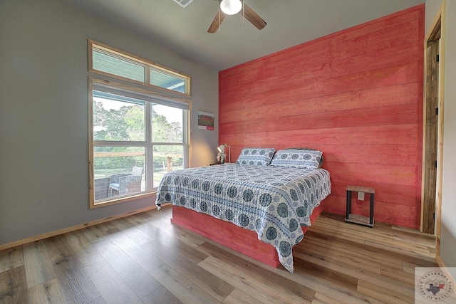 bedroom with ceiling fan and light hardwood / wood-style flooring