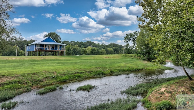 view of property's community featuring a water view and a yard