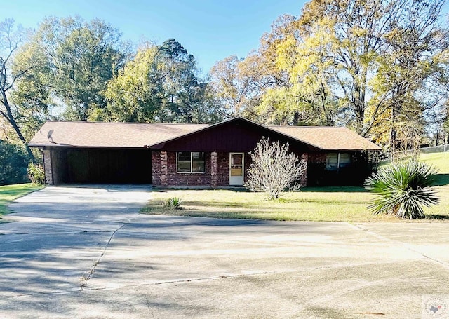 ranch-style home featuring a front yard and a carport