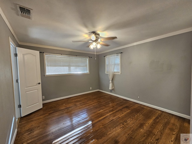 empty room featuring ceiling fan, crown molding, and dark hardwood / wood-style floors