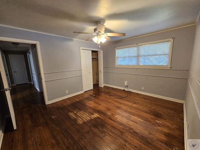 unfurnished bedroom featuring crown molding, dark wood-type flooring, and ceiling fan