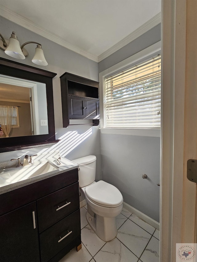 bathroom featuring vanity, toilet, and ornamental molding