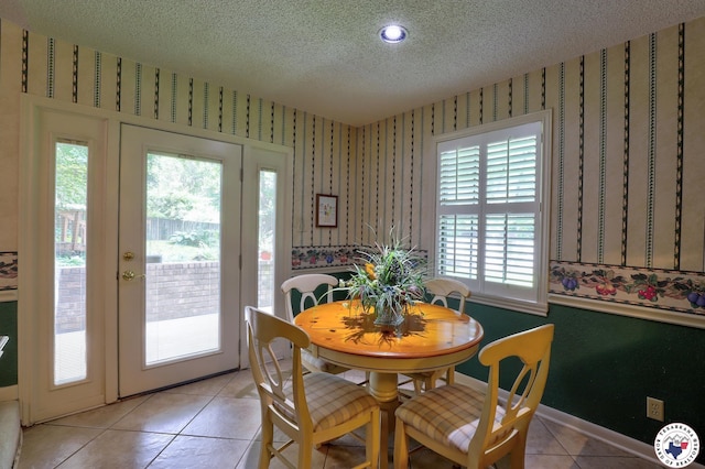 21 Holly Ridge Dr, Texarkana, TX 75503 - dining area featuring a textured ceiling, wallpapered walls, light tile patterned floors, and plenty of natural light