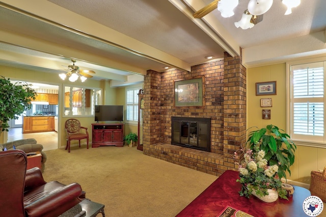 21 Holly Ridge Dr, Texarkana, TX 75503 - living area with carpet, a brick fireplace, a ceiling fan, and beam ceiling