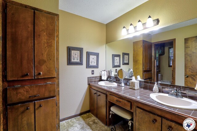 21 Holly Ridge Dr, Texarkana, TX 75503 - full bathroom with double vanity and a textured wall