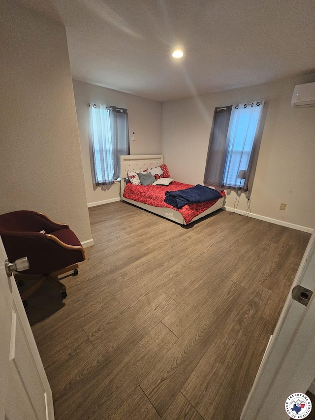 3514 Magnolia St, Texarkana, TX 75501 - bedroom with a wall mounted AC, wood finished floors, and recessed lighting