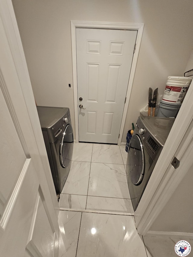 3514 Magnolia St, Texarkana, TX 75501 - laundry room featuring light marble finish floors and washing machine and clothes dryer