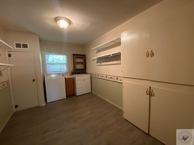 kitchen featuring white cabinetry, hardwood / wood-style floors, and washer / dryer