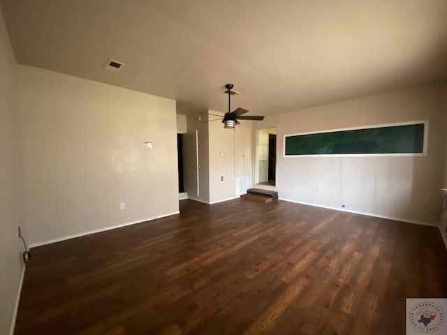 unfurnished living room with ceiling fan and dark wood-type flooring